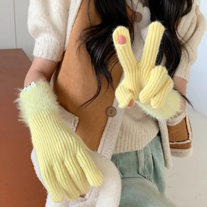 Detailed knit texture of yellow warm gloves with fluffy faux fur cuffs for women