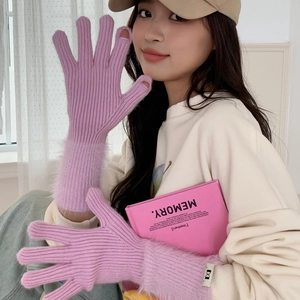 Detail of purple knitted gloves with pink faux fur trim and touch-screen finger openings