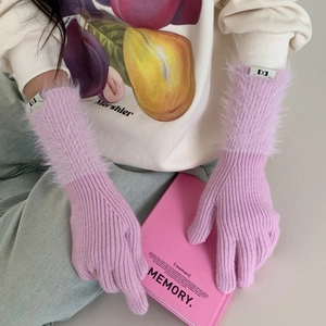Close-up of lavender knit gloves with plush thermal cuffs and woven logo detail