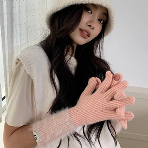 Close-up of pink knit gloves with faux fur cuffs and touchscreen finger openings