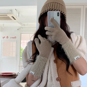 Detail of winter knit gloves with plush faux fur cuffs and matching beanie set