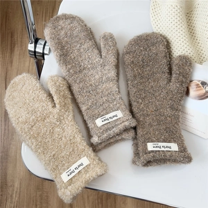 Thick plush mittens in beige and camel colors made of soft curly fleece for winter warmth