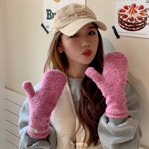Close-up of pink fluffy fleece mittens for women featuring soft textured warm material