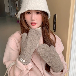 Detailed texture of khaki teddy fleece mittens with white brand label on soft wrist cuff