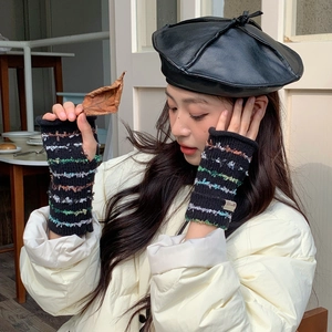 Detail of colorful striped knitted fingerless gloves paired with stylish winter outfit