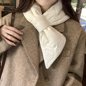 Detail of white quilted down scarf with wave stitching and branded label styling