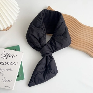 Detail of black heart-quilted down scarf with convenient cross-insert design and warm lining