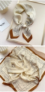 Detail of vintage French style silk scarf featuring black line art illustrations and brown border
