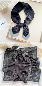 Detail of elegant black silk square scarf with white vintage floral prints in a frame