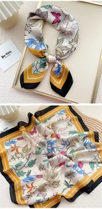 Detail of colorful butterfly silk scarf with yellow and black contrast edges and prints