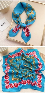 Close-up of silk square scarf featuring gold chains and pink rose floral pattern