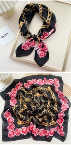 Close-up of silk square scarf featuring elegant red roses and golden chain patterns