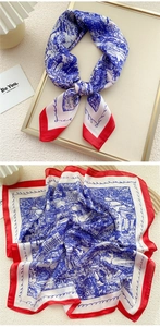 Detail of blue Toile de Jouy silk scarf with red borders and artistic lettering