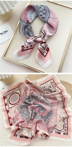 Detailed view of a vintage pink silk scarf with geometric patterns and chic motifs