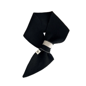 Minimalist black knit scarf with white cross-fixing band and soft texture on white background