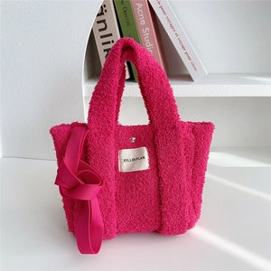 Detail of rose pink fleece tote with magnetic snap closure and HILLDIPLAN label