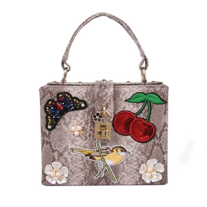 Sac à main effet serpent avec broderie oiseau et fleurs de perles sur fermoir