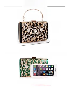 Detailed dimensions of crystal evening clutch bag shown next to a smartphone for scale