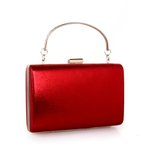 Close-up of red evening clutch featuring metallic finish and gold circular handle