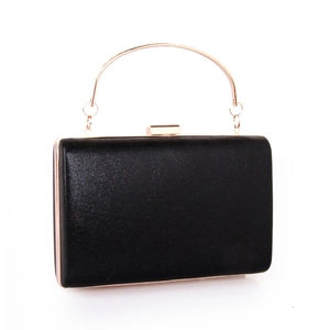 Detail of black satin evening clutch bag with gold metal handle and snap closure