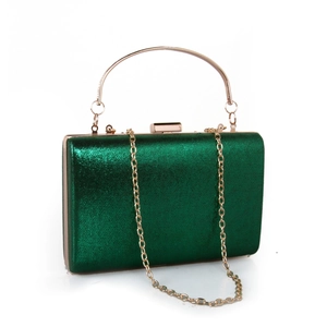 Detail of green glitter evening clutch bag with gold metal handle and chain strap