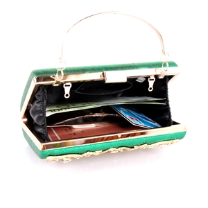 Interior view of emerald glitter evening clutch bag showing capacity for phone and accessories