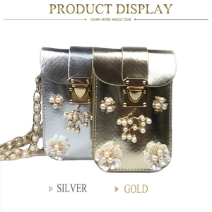 Detailed close-up of pearl flower ornaments and diamond studding on vertical phone bags