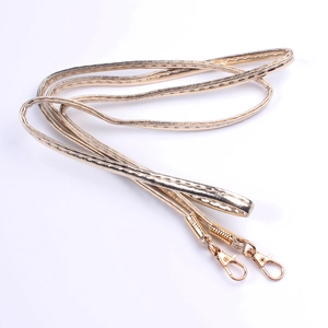 Detail of golden PU leather shoulder strap with sturdy metallic lobster clasps