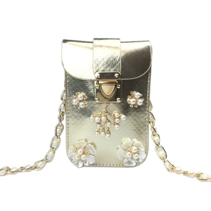 Detail of gold floral crossbody phone bag with pearl flower charms and chain strap