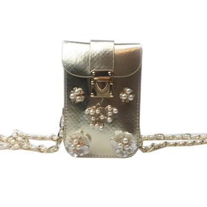 Detail of gold phone bag with white pearl floral decor and metallic chain strap