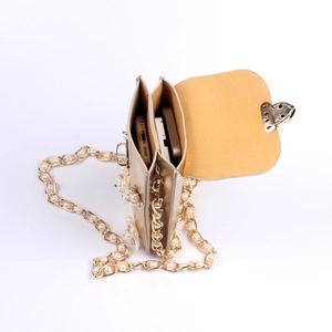 Detail showing dual compartments of floral champagne crossbody bag with pearl chain strap