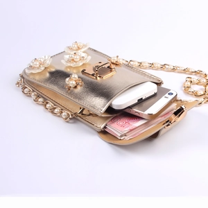 Detail showing inner compartments of the pearl flower phone bag with gold metal finish