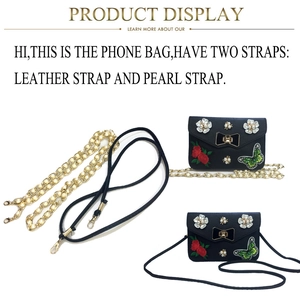 Detail of black butterfly embroidery bag with dual pearl chain and leather straps