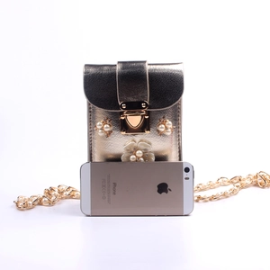 Mini floral gold crossbody phone bag shown with smartphone for size scale comparison