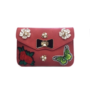 Red crossbody leather bag featuring pearl flowers and butterfly embroidery design