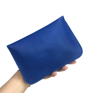 Detail of dark blue litchi pattern leather cross-body bag with refined stitching