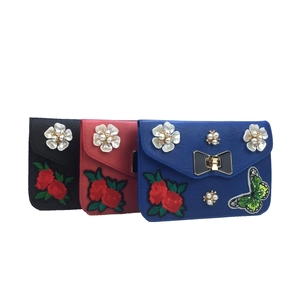 Detail of crossbody bag with floral embroidery, 3D pearl flowers and butterfly sequins