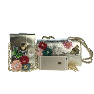 Detail of gold evening bags with 3D floral embroidery, pearl chain, and sequined bee charms