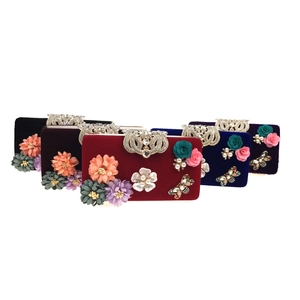 Group view of velvet evening clutch bags with 3D floral accents and pearl embellishments