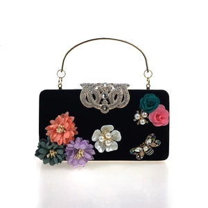 Luxurious black velvet evening clutch with 3D satin flowers, pearls, and a jeweled bee