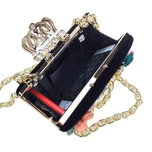 Elegant black velvet evening clutch with 3D floral petals and gold crown clasp