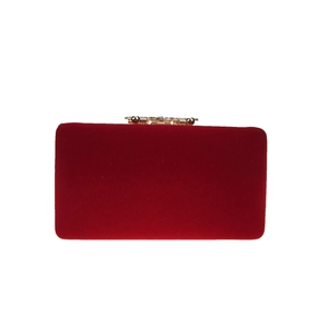 Detail of burgundy velvet evening bag with gold metal clasp and pearl diamond accents