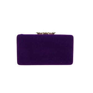 Detail of purple velvet evening clutch with ornate gold floral diamond clasp closure