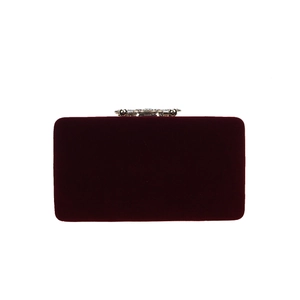 Macro shot of burgundy velvet clutch with crystal floral metal clasp and hardware