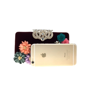 Velvet evening clutch size comparison with deep red fabric and multi-color floral decor