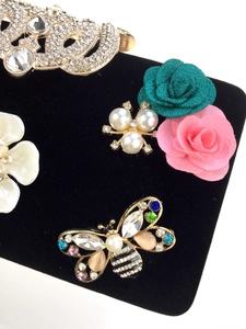 Macro detail of luxury butterfly brooch with crystals and pearl fabric flowers
