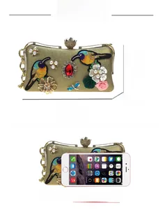 Detailed size comparison of embroidered floral evening bag with iPhone showing 20x11x6cm capacity