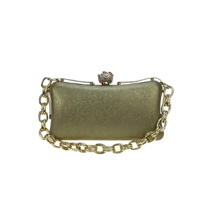 Detail of gold evening clutch with crystal skull clasp and metallic crossbody chain strap