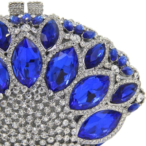 Macro shot of blue marquise crystal rhinestones and metal frame on luxury clutch bag