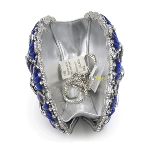 Detailed interior of luxury evening clutch with blue navette crystals and silver chain